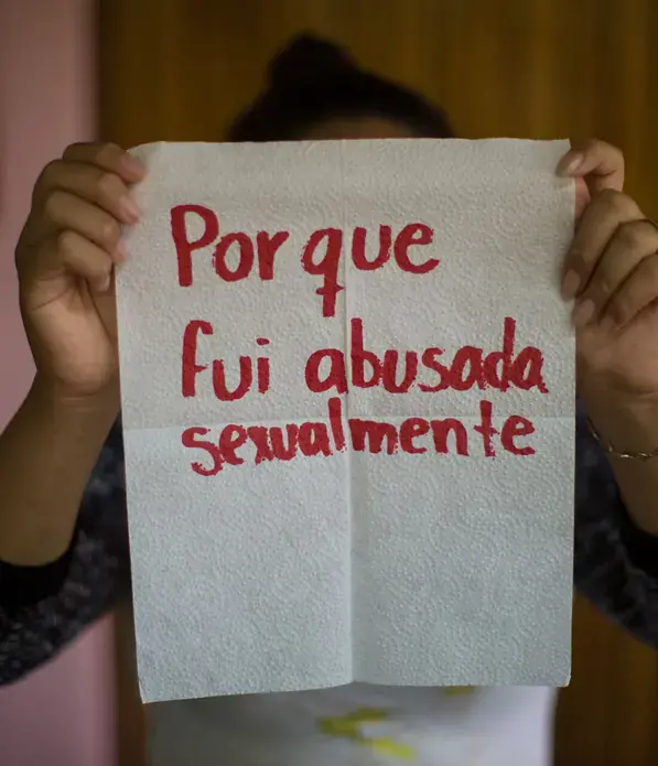 Saraí, 17.</p>
<p>The napkin reads: 'because I was sexually abused.' She's unable to forget her stepfather, who fondled her when she was only five years old. Saraí started working as a street vendor in buses when she was 7. And the abuse changed. sometimes her grandmother hit her so hard with cables or pieces of wood that her skin showed marks. Even so, now she helps younger children.</p>
<p>Image by Almudena Toral. El Salvador, 2018.