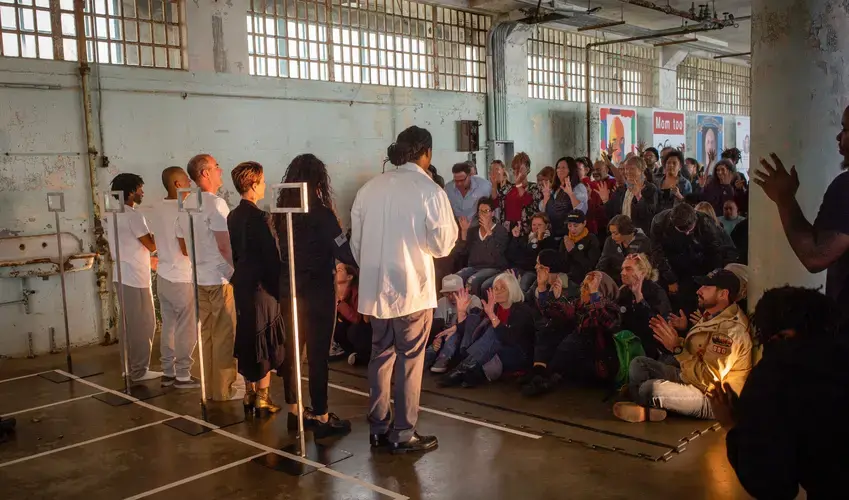 Actors and audience after a 2019 performance of The BOX on Alcatraz Island. These performances were produced in partnership with the Pulitzer Center. Image by Robert Gumpert. United States, 2019.