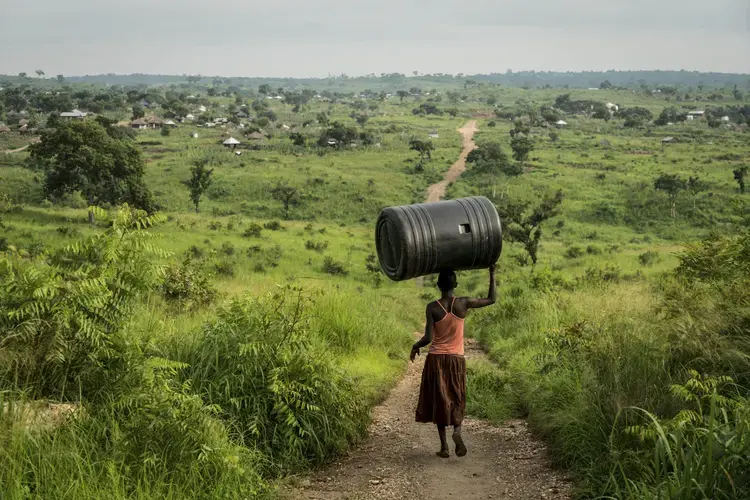 A woman carries a water tank through the Omugo settlement for refugees that have fled from South Sudan to Uganda. Uganda is the largest refugee hosting country in Africa, supporting 1.2-million people.