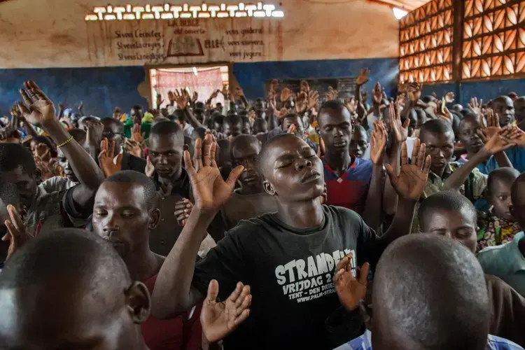 Christians pray at a church in Bambari, where Muslims burned hundreds of their homes. Churches in many towns gave refuge to both Christians and Muslims fleeing violence. Says one pastor: “God’s people stepped in to help when soldiers and politicians fled.” Image by Marcus Bleasdale. Central African Republic.