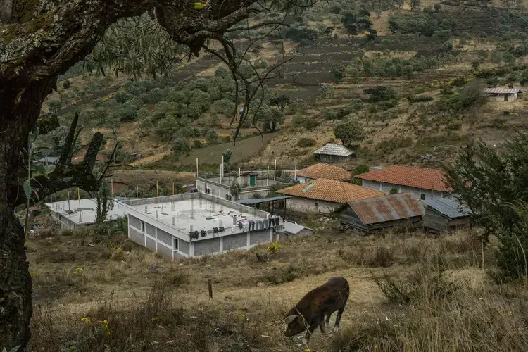 A compound that was built using remittance money sits unfinished on the outskirts of the municipality of Todos Santos Cuchumatán. Image by Mauricio Lima. Guatemala, 2019.