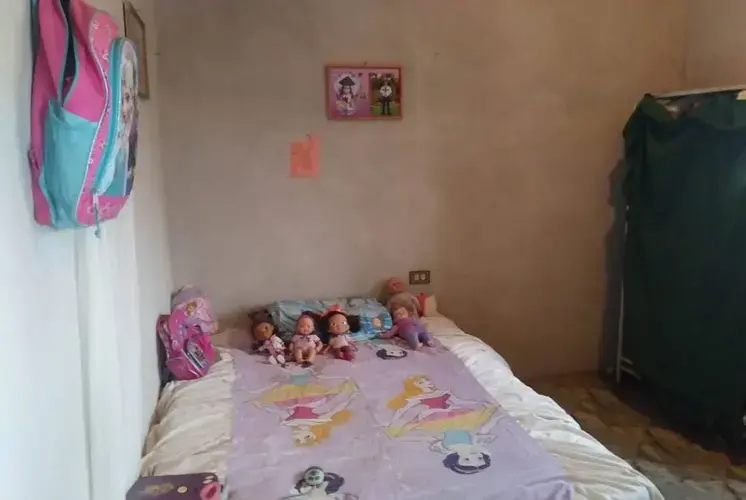 Heyli's bedroom in San Francisco de la Paz, Honduras. Heyli, a first-grader, is learning to read and write, and her mother said she was excited for the trip to the U.S. 'My daughter left happy,' said Heyli's mother. 'She likes to travel a lot.' Image by Jay Root. Honduras, 2018.