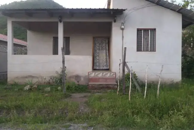 The rental home in San Francisco de la Paz where 6-year-old Heyli lived with her father and mother before setting out for the U.S. on May 15. 'Here, you can't live normally,' Claudia's mother said of the town. 'You can't be out after 6 p.m., 6:30 p.m., 7:00 p.m. ... because they assault you or they will kill you.' Image by Jay Root. Honduras, 2018.