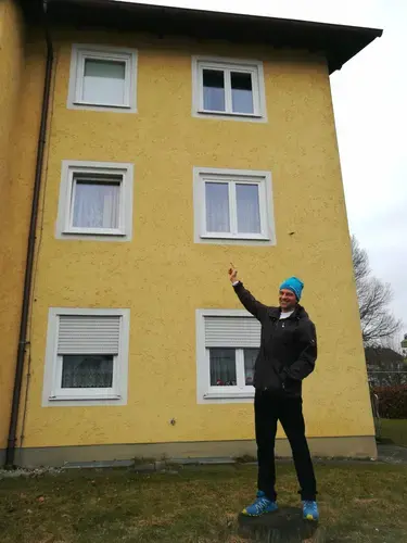 Oliver Koglot stands in front of his childhood home in Traunreut. Koglot helped organize two anti-immigrant rallies in the city with help from the far-right Alternative for Germany party. He arrived in Traunreut in the '80s with his family as German immigrants from Romania. Image by Frank Hessenland. Germany, 2017.