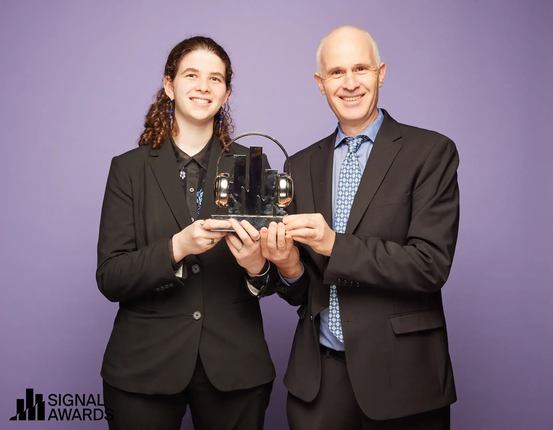 Micah and Sydney Fink accept a Signal Award