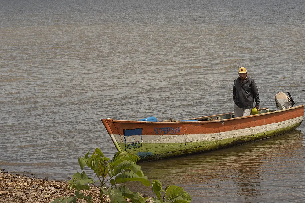 Fisherman stands in boat