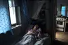 Angela Orlov lays in bed in her home in Balti, Moldova.