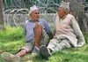 Two elderly men sit under a shade in Kathmandu discussing the country's politics. Nepal is holding elections to select a new prime minister for the ninth time in the last two months. Image by Anup Kaphle. Nepal, 2010.