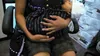 Su Su, a refugee from Burma, holds her 4 week old baby one week after they both were released from detention.