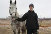 Ozdemir Tsipinov, 19, holds Makhosh, the horse thatbelonged to his father, Aslan Tsipinov, 51, who was murdered by Islamist gunmen on December 29, 2010, in Shalushka village, near Nalchik, in the Russian republic of Kabardino-Balkaria. Image by Tom Parfitt. Russia, February 2011.