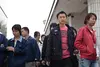 Workers stream out of factories for their 11:30am lunch in the Longgang district, a hub of manufacturing in Shenzhen, Guangdong Province. Image by Jocelyn Baun. China, 2011.