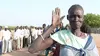 Nyayouk Duok making her intentions clear at the polling center. The open hand was the ballot symbol for “separation” from Sudan, which would create the world’s newest nation. Pictorial symbols were placed on the ballot in a country where 85 percent of the population cannot read or write. Image by Fred de Sam Lazaro. Sudan, 2011.