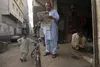 Shop owner Mubashir Zubair with two employees.Photo: Alex Stonehill