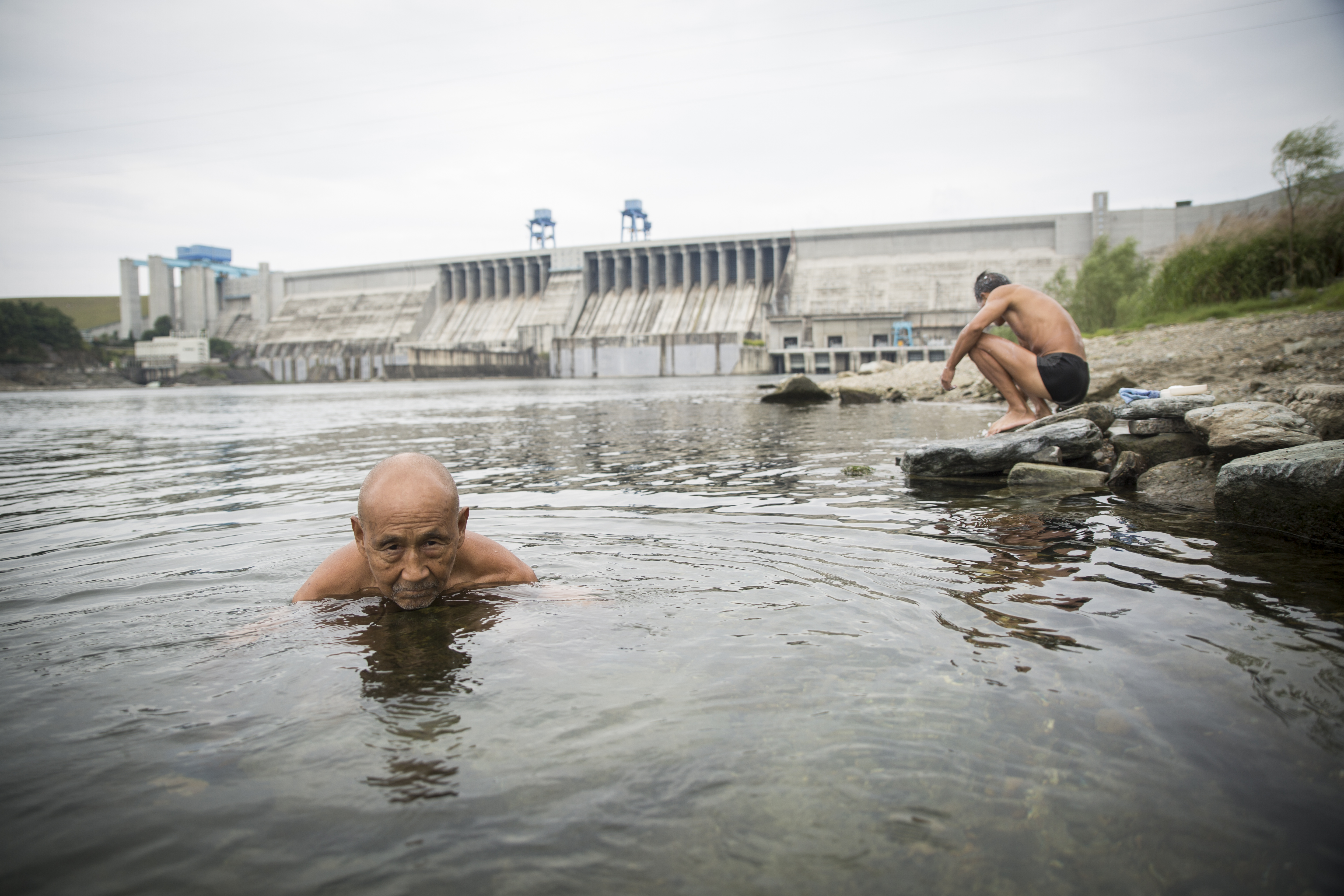 People swim by the Danjiangkou Dam in central China. Image by Sharron Lovell. China, 2015.