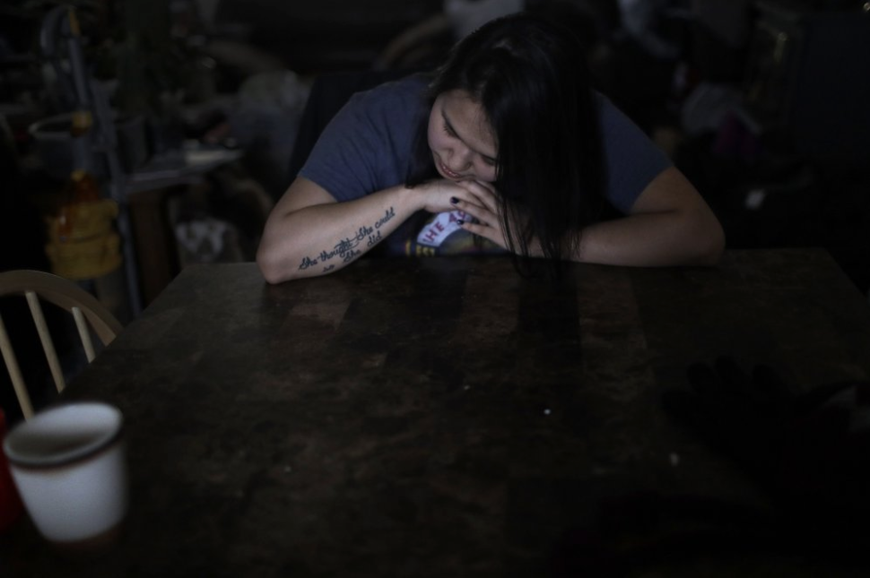In this Feb. 16, 2019, photo, Deidre Levi rests her head for a moment in her grandmother's house before a basketball game in the Native Village of St. Michael, Alaska. Levi says she spoke up about being sexually assaulted because she wanted to be a role model for girls in Alaska. Image by Wong Maye-E. United States, 2019. In this Feb. 16, 2019, photo, Deidre Levi rests her head for a moment in her grandmother's house before a basketball game in the Native Village of St. Michael, Alaska. Levi says she spoke up about being sexually assaulted because she wanted to be a role model for girls in Alaska. Image by Wong Maye-E. United States, 2019.