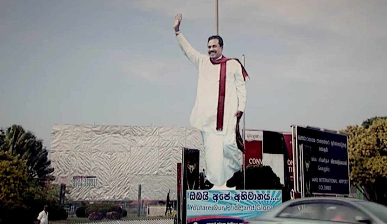 Still from the film "No Fire Zone" showing a statue of president Mahinda Rajapaksa. Media file: -1.png