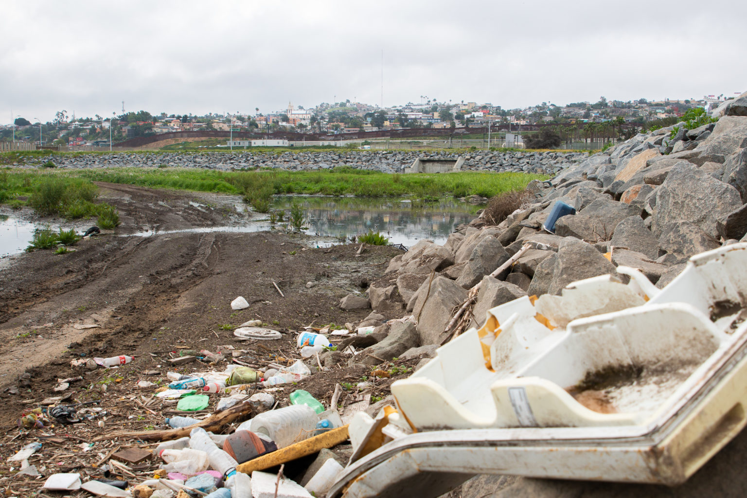 Trash is piled near the U.S.-Mexico border, where sewage from Tijuana flows through. Image by Adriana Heldiz / Voice of San Diego. Trash is piled near the U.S.-Mexico border, where sewage from Tijuana flows through. Image by Adriana Heldiz / Voice of San Diego.