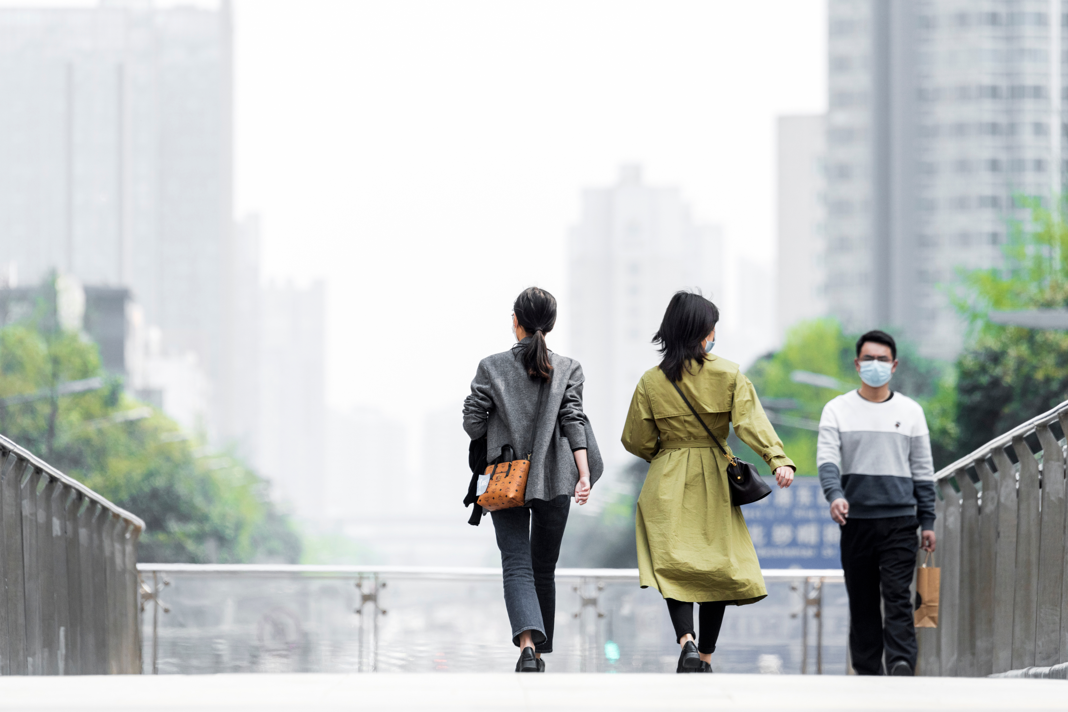Shopping citizens in China's downtown center wear masks as the city recovers from the COVID-19 epidemic. Image by B.Zhou/Shutterstock. China, 2020 Shopping citizens in China's downtown center wear masks as the city recovers from the COVID-19 epidemic. Image by B.Zhou/Shutterstock. China, 2020