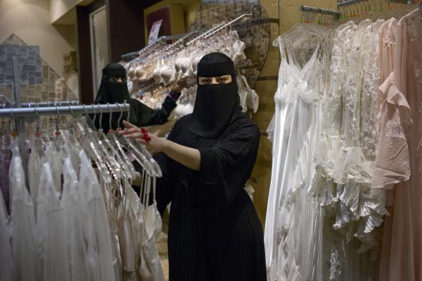 Saudi women have begun to work in retail jobs, particularly in businesses that serve mainly female customers, but including supermarkets. Nermin Abdulaziz Molhim, 27, interviews and trains new Nayomi hires. Nayomi is a popular lingerie shop. Image by Kate Brooks. Saudi Arabia, 2013.