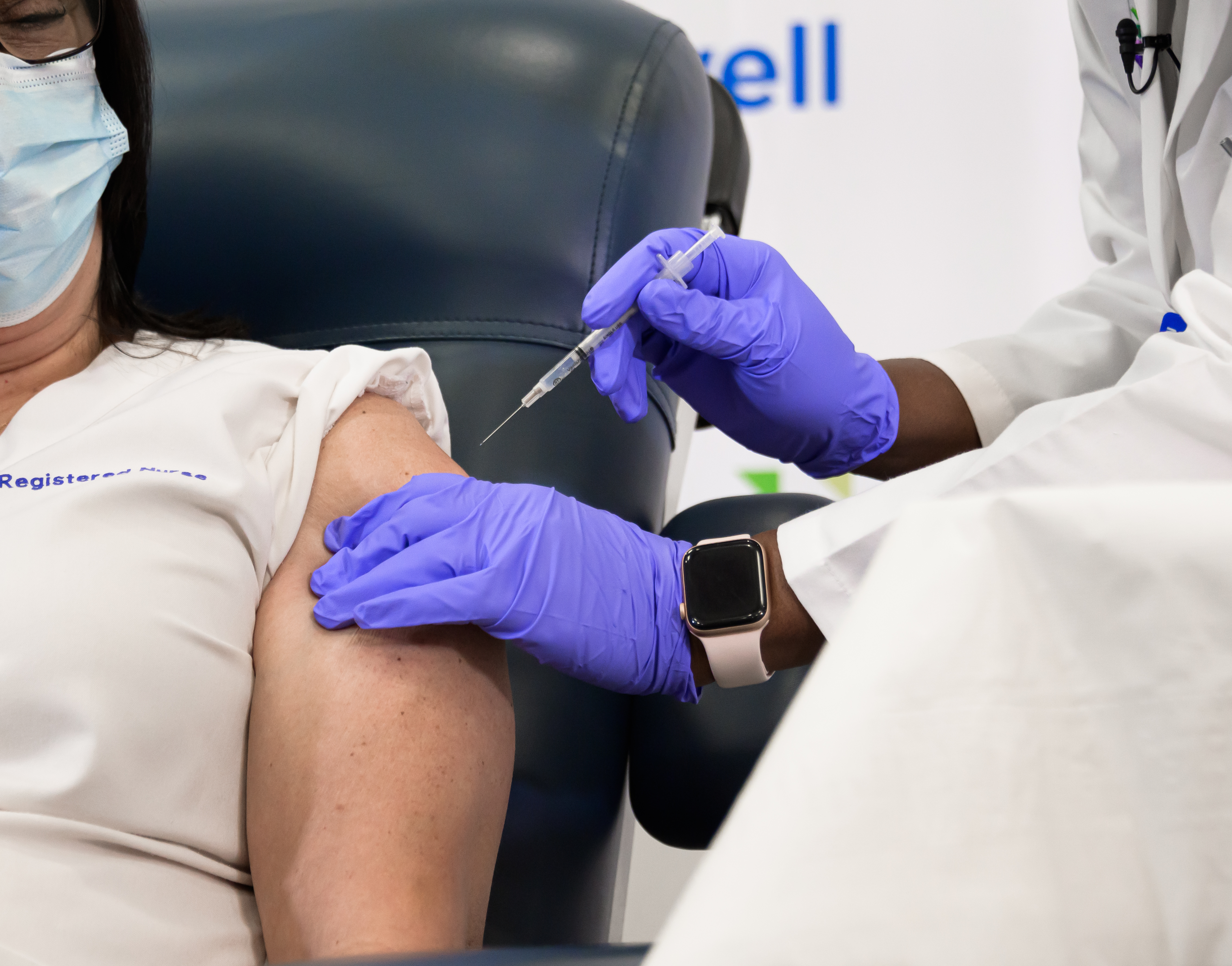 A medical worker administers the Pfizer-BioNTech COVID-19 vaccine to an ICU nurse at the Long Island Jewish Medical Center. Image by noamgalai / Shutterstock. United States, 2020. A medical worker administers the Pfizer-BioNTech COVID-19 vaccine to an ICU nurse at the Long Island Jewish Medical Center. Image by noamgalai / Shutterstock. United States, 2020.