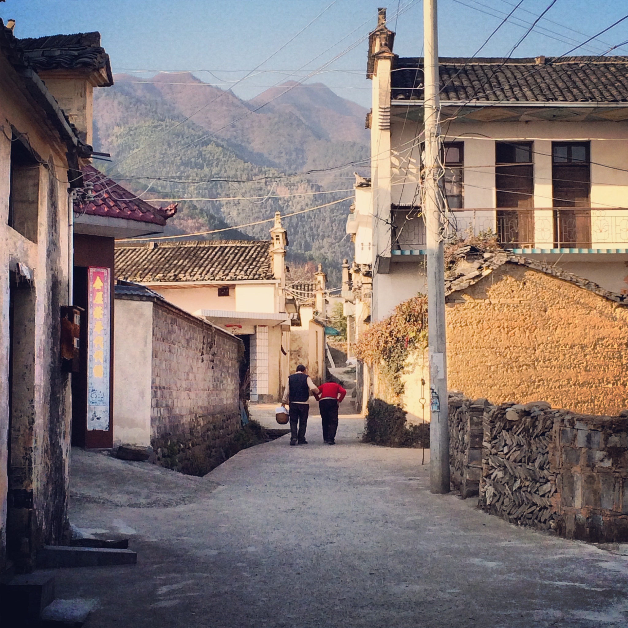 A senior villager helping her mother-in-law walk. Image by Sun Yunfan. China, 2013. Media file: 14.jpg
