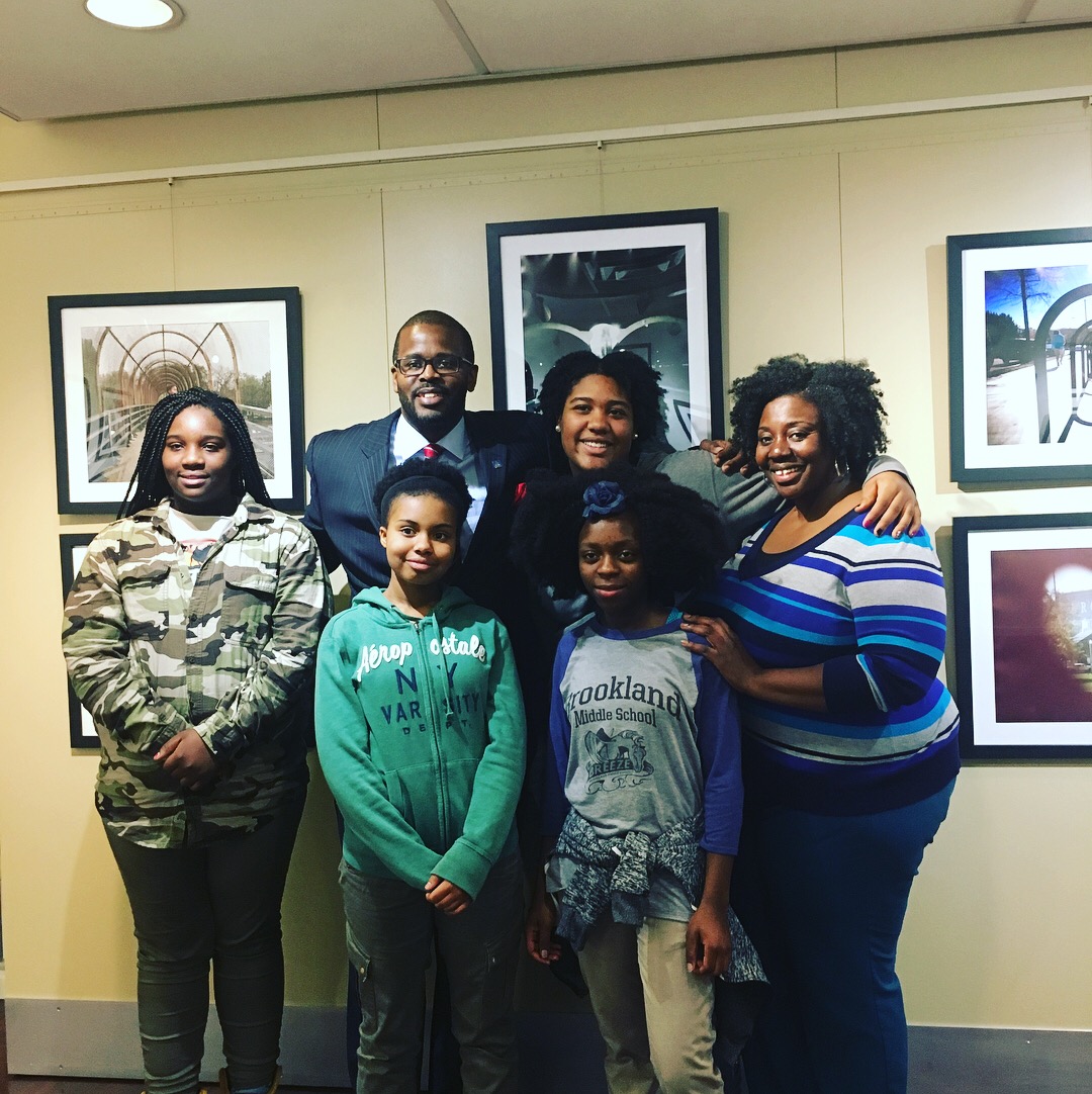 Washington, D.C. Public Schools Chancellor Antwan Wilson visits the Everyday DC exhibit with its student curators and their teacher. Image by Fareed Mostoufi. United States, 2018. Washington, D.C. Public Schools Chancellor Antwan Wilson visits the Everyday DC exhibit with its student curators and their teacher. Image by Fareed Mostoufi. United States, 2018.
