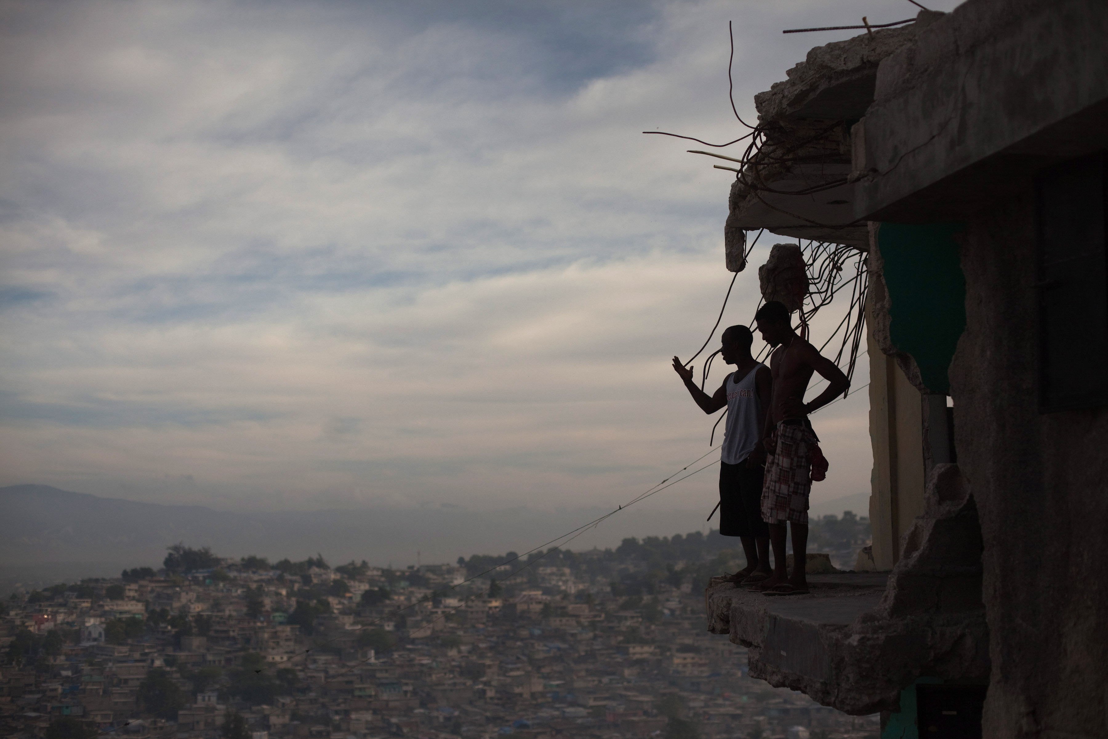 Horlich Florestal (left), 24, and Rosemond Altidon, 22, stand on the edge of their apartment building in Fort National January 9, 2011. Half the building was destroyed in the earthquake, killing many of their neighbors, including two cousins and an aunt. Image Allison Shelley. Haiti, 2011. Horlich Florestal (left), 24, and Rosemond Altidon, 22, stand on the edge of their apartment building in Fort National January 9, 2011. Half the building was destroyed in the earthquake, killing many of their neighbors, including two cousins and an aunt. Image Allison Shelley. Haiti, 2011.