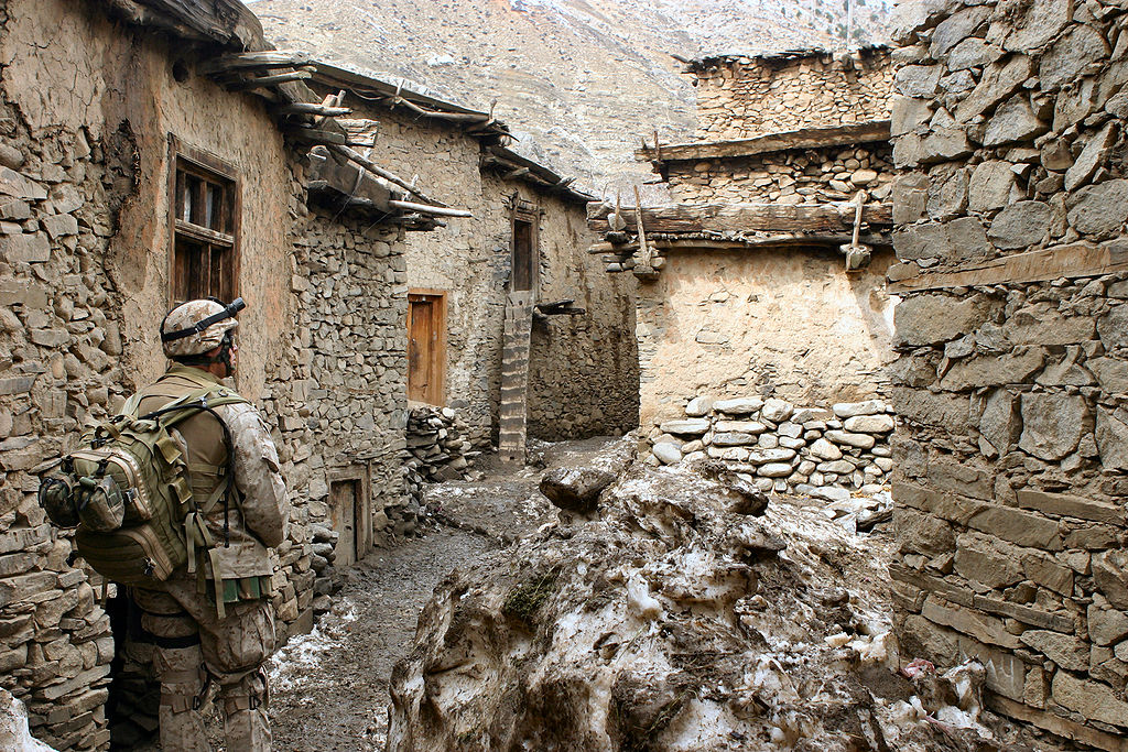 A soldier walks through an alley in the vicinity of Methar Lam. Image by Cpl. James L. Yarboro. Afghanistan, 2005. A soldier walks through an alley in the vicinity of Methar Lam. Image by Cpl. James L. Yarboro. Afghanistan, 2005.