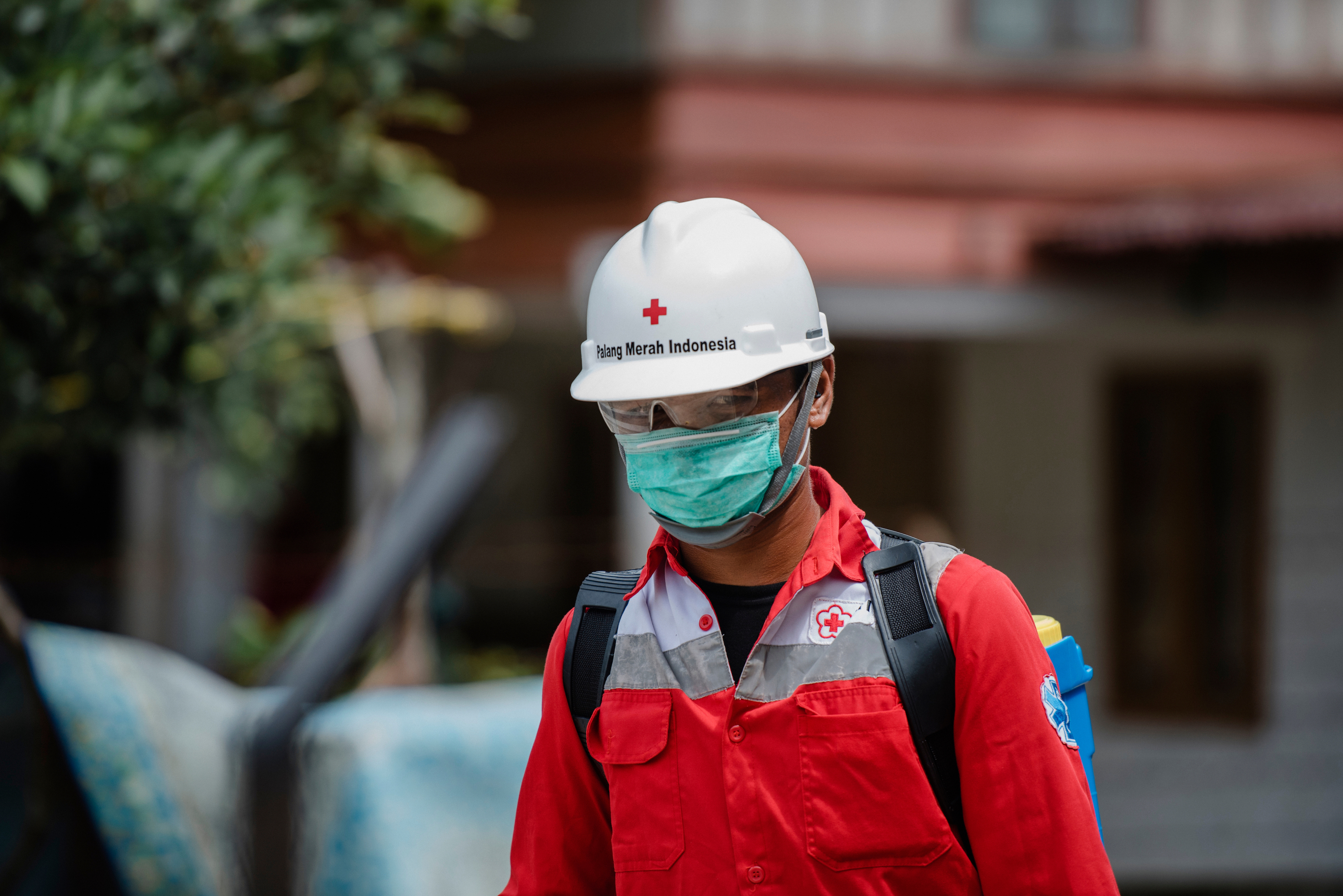 A Red Cross volunteer working to prevent the spread of COVID-19. Image by rizaazhari/shutterstock. Indonesia, 2020. A Red Cross volunteer working to prevent the spread of COVID-19. Image by rizaazhari/shutterstock. Indonesia, 2020.