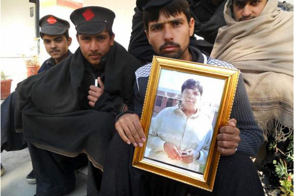 A student holds a portrait of Aitzaz at his school in Hangu, Pakistan. Image by The Friday Times. Pakistan, 2014. Media file: tft-49-p-1-e-600x400.jpg