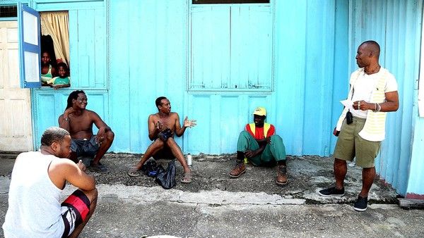 Wayne (right), a teacher and community leader, runs a nursery for struggling local families in Hell Yard in Beetham Gardens, one of Trinidad’s most notorious neighborhoods. Image by Andrea de Silva. Trinidad and Tobago, 2013.