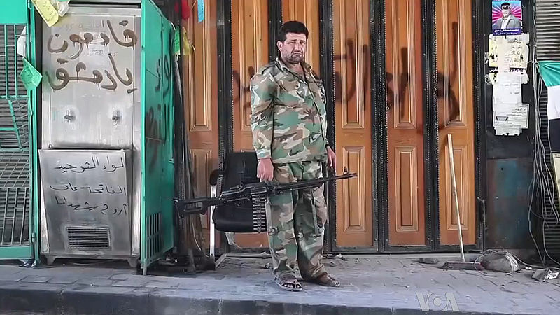 Free Syrian Army soldier in Aleppo. Image by Voice of America News: Scott Bobb. Courtesy of Wikimedia Commons. Syria, 2013. Media file: 800px-free_syrian_army_soldier_with_machine_gun_in_aleppo.jpg