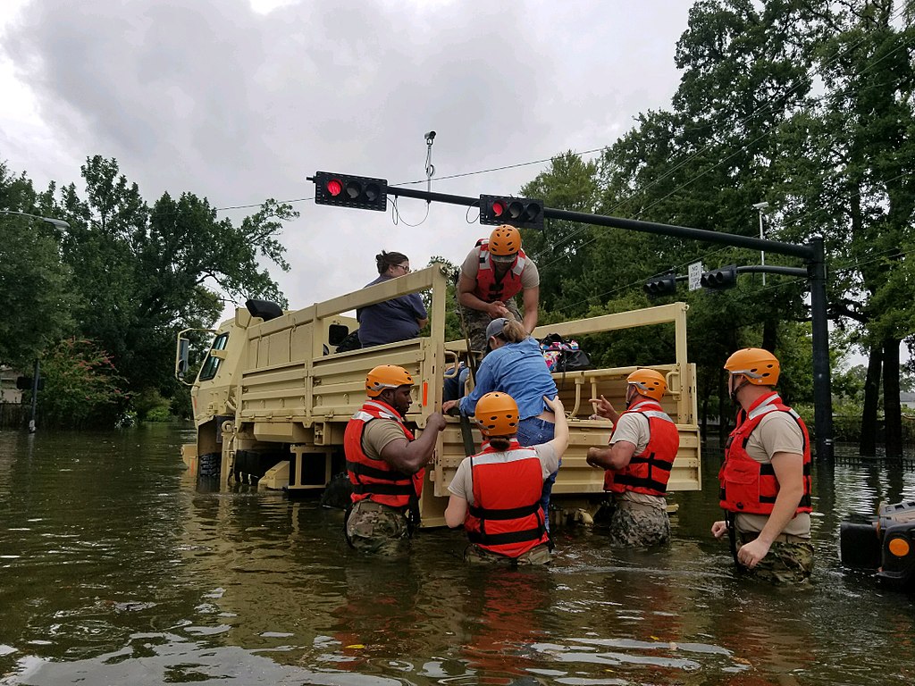 Texas National Guard soldiers rescue a civilian in flooded areas around Houston, Texas on, 27 August, 2017. Image by 1Lt. Zachary West, 100th MPAD. United States, 2017. Texas National Guard soldiers rescue a civilian in flooded areas around Houston, Texas, on 27 August, 2017. Image by 1Lt. Zachary West, 100th MPAD. United States, 2017.