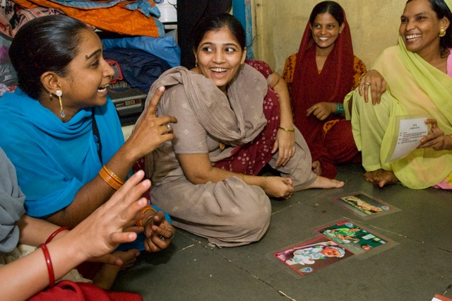 A women’s group in a Mumbai slum playing a picture card game where they are learning about health care options during pregnancy. Image by Rebecca Sherman. Media file: 0222CM DSC_0458.jpg