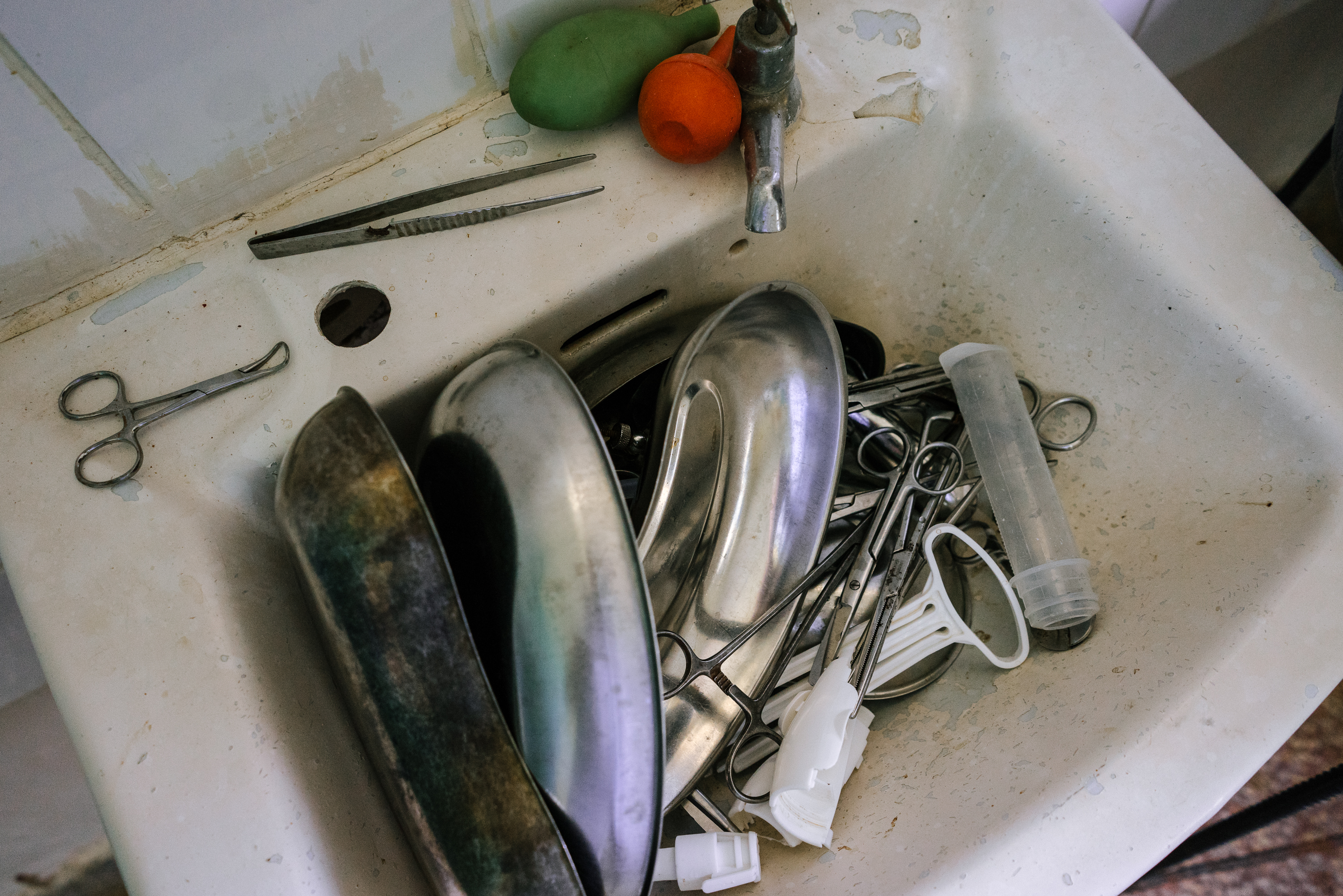Instruments in the maternity ward at the Bumula Health Center. The clear plastic tube at right is part of a manual vacuum aspirator, a tool used in abortions at this and other clinics in the area. Image by Jake Naughton. Kenya, 2015. Media file: kenya-abortion-9323.jpg