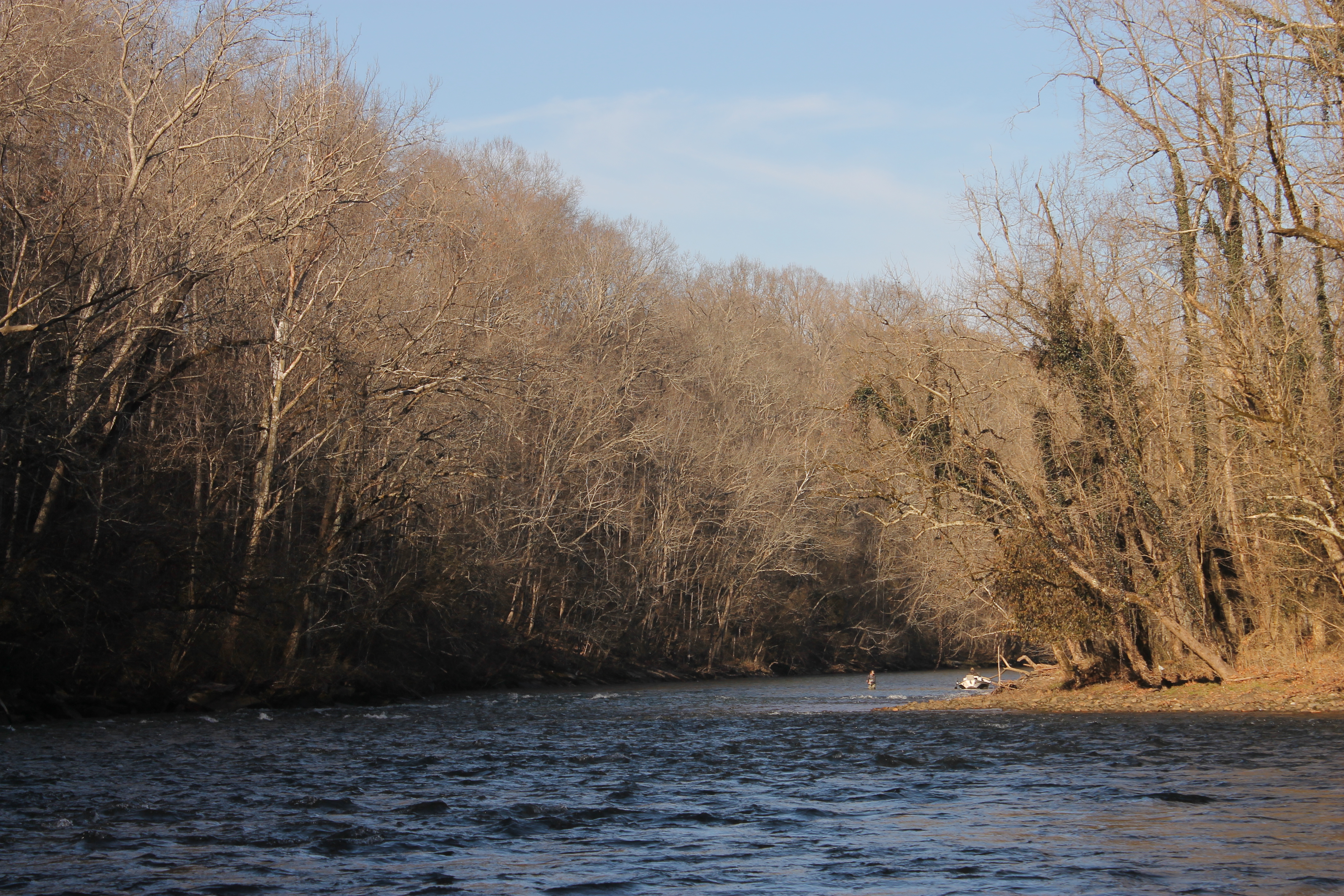 A fisherman wades into the Watauga River. Image by Emma Johnson. United States, 2021. A fisherman wades into the Watauga River. Image by Emma Johnson. United States, 2021.