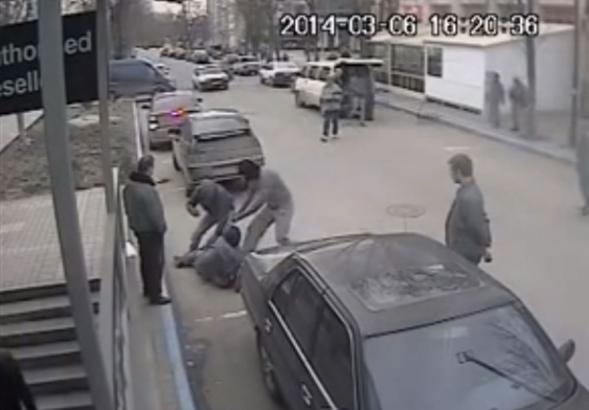 Security camera still of attack in Simferopol on Dimiter Kenarov, Pulitzer Center grantee journalist, who had been photographing a midday raid against a TV studio—part of the Associated Press network he later learned. The video footage taken by chance by the security camera was later traced and uploaded on YouTube by Ukrainian journalists. Ukraine, 2014. Media file: attack_on_dimiter.jpg