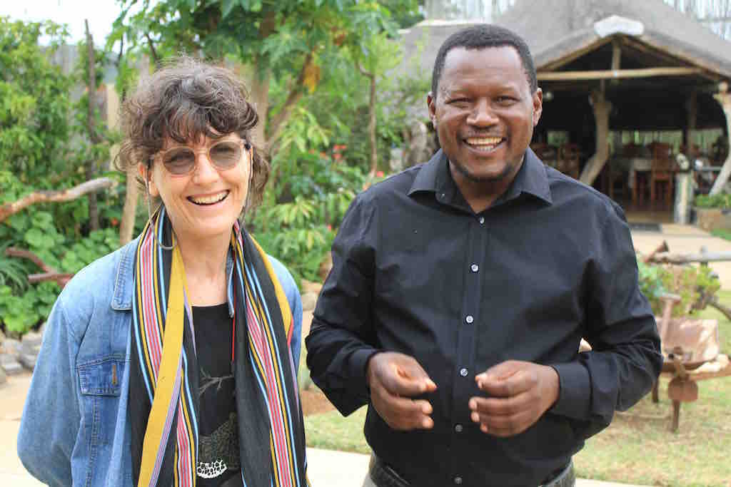 In the field: Journalist Michelle Nel (left) with Pastor Solly Mhaule, a community elder who believes the Public Protector needs to investigate the MalaMala land deal. Image by Dennis Scully. South Africa, 2019. In the field: Journalist Michelle Nel (left) with Pastor Solly Mhaule, a community elder who believes the Public Protector needs to investigate the MalaMala land deal. Image by Dennis Scully. South Africa, 2019.