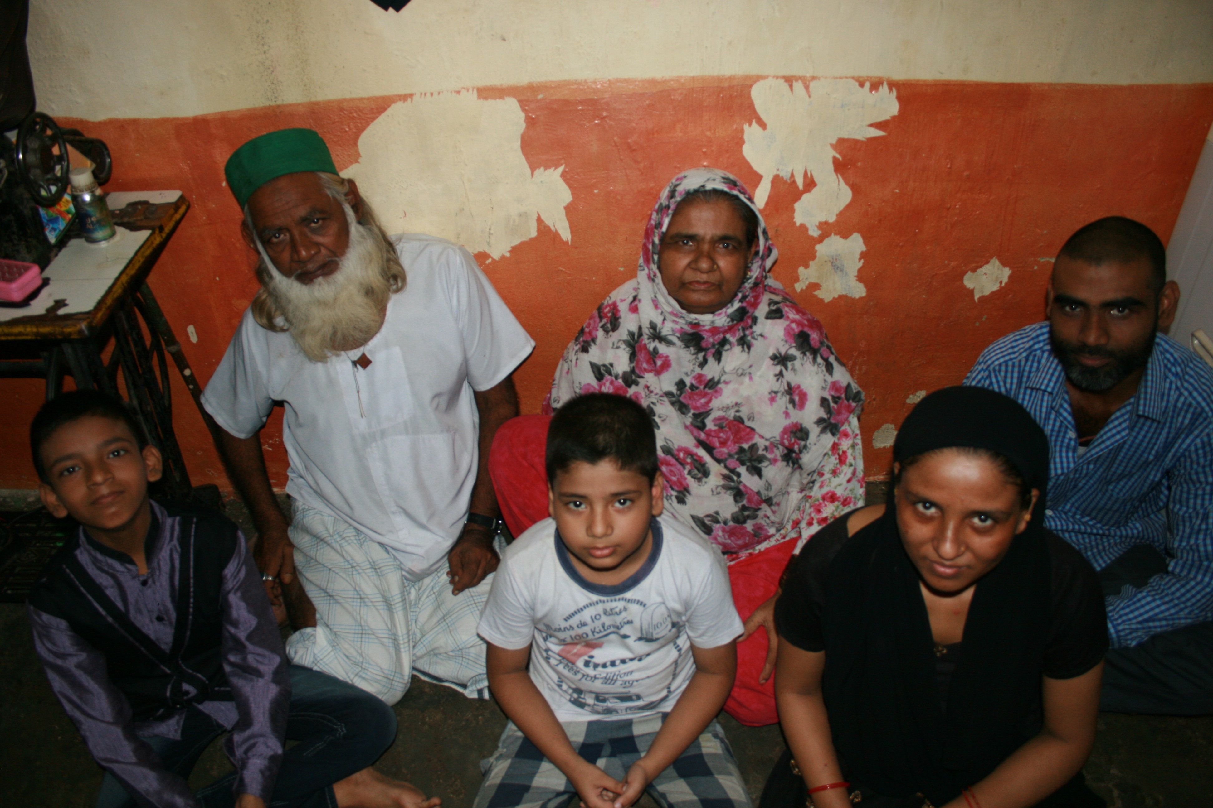 Shamin Ansari, 14 (left) lives with his brother, parents, and grandparents in a one-room flat in Shivaji Nagar in Mumbai. Born with intellectual disabilities, Shamin’s family worked with Apnalaya, a local NGO, to obtain the government-issued disability certificate required for his admission into a special school. Image by Kate Petcosky-Kulkarni. India, 2016. Shamin Ansari, 14 (left) lives with his brother, parents, and grandparents in a one-room flat in Shivaji Nagar. Born with intellectual disabilities, Shamin’s family worked with Apnalaya, a local NGO, to obtain the government-issued disability certificate required for his admission into a special school. Image by Kate Petcosky-Kulkarni. Mumbai, India, 2016.