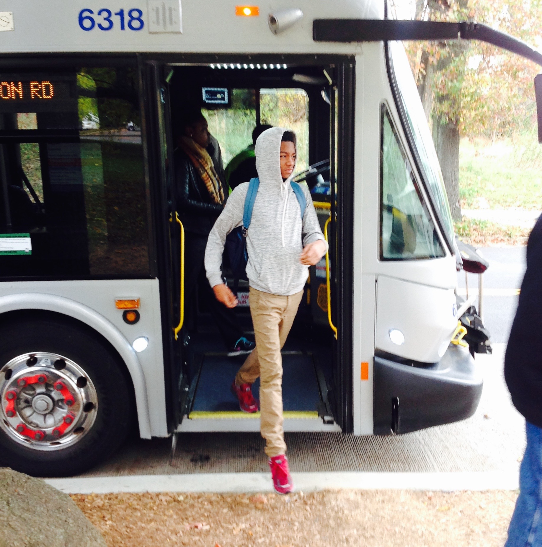 A student from Johnson Middle School captures a classmate departing a public bus while taking photographs representing her experience of daily life in Washington, D.C. Image by a a visual arts student from Johnson Middle School. Washington, D.C., 2017. Media file: img_0140.jpg