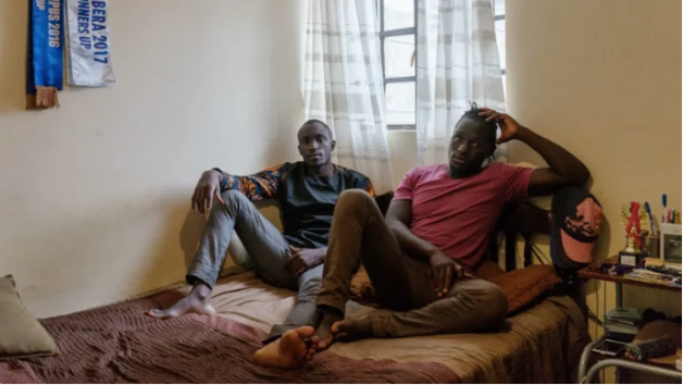Collince Onyango, 27, left, and his brother Raphael Oduor, 24, right, both university students, in their home in Kibera, Nairobi, Kenya. Collince and his brother rent a single room from a resident who was lucky to move into the new houses that were built under the Kenya Slum Upgrading Project. Image by Peter DiCampo. 2018. Collince Onyango, 27, left, and his brother Raphael Oduor, 24, right, both university students, in their home in Kibera, Nairobi, Kenya. Collince and his brother rent a single room from a resident who was lucky to move into the new houses that were built under the Kenya Slum Upgrading Project. Image by Peter DiCampo. 2018.
