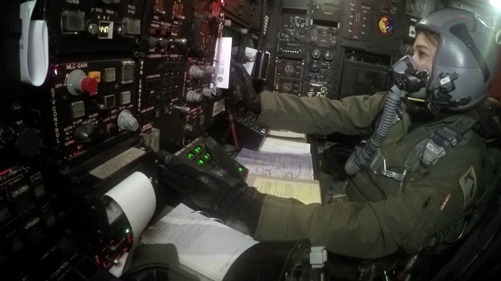 Air Force Capt. Margaret Ingerslew at the weapons controls of a B-52H bomber. This giant aircraft carries tons of munitions and fuel, but space for the crew is quite cramped. Photo by Daniel Sagalyn. United States, 2016. Air force nuclear controls