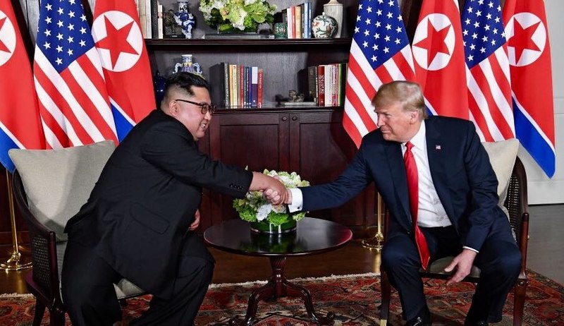 Trump and Kim shaking hands in the summit room during the DPRK-USA Singapore Summit. Image by Shealah Craighead/Wikimedia Commons. Singapore, 2018. Trump and Kim shaking hands in the summit room during the DPRK-USA Singapore Summit. Image by Shealah Craighead/Wikimedia Commons. Singapore, 2018.