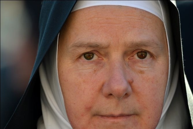 A nun takes a place on St. Peter's Square ahead of Pope Benedict XVI's last weekly audience on February 27, 2013 at the Vatican, on the eve of Benedict's historic resignation as leader of the world's 1.2 billion Catholics. Image by Gabriel Bouys. The Holy See, 2013.