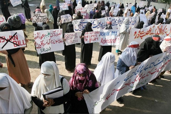 Pakistani women protest the passage of a women's rights bill modernizing laws affecting rape victims Dec. 1, 2006 in Lahore, Pakistan. The country faces severe challenges to solving its sexual violence crisis from religious fundamentalists. Image by Arif Ali. Pakistan, 2013. Media file: Screen Shot 2013-03-01 at 4.17.58 PM.jpg
