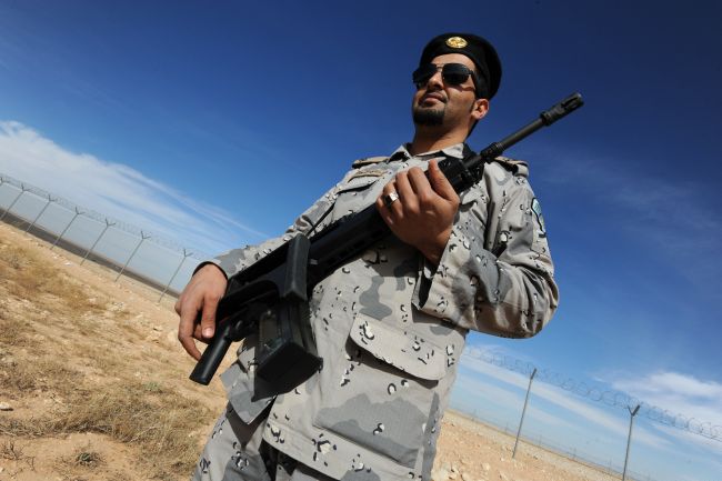A member of the Saudi border guards forces patrols the fence on Saudi Arabia's northern border with Iraq, near Arar City on February 23, 2015. Saudi Arabia increased its security measures along its frontier with Iraq following attacks launched by the Islamic State (IS) group against Saudi troops and security posts along the border. Image by Fayez Nureldine, AFP/Getty Images. Saudi Arabia, 2015.