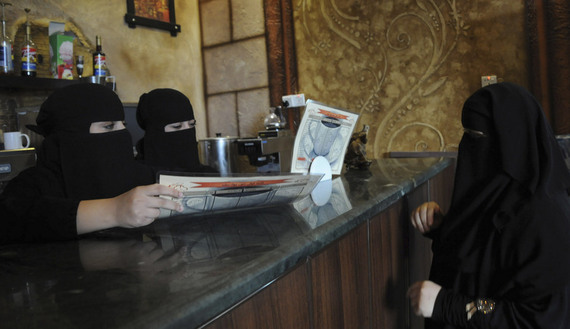 Veiled Saudi women work at a coffee shop in Tabuk, 1,500 kilometers (932 miles) from Riyadh. Image by Mohamed Alhwaity, REUTERS. Saudi Arabia, 2013.