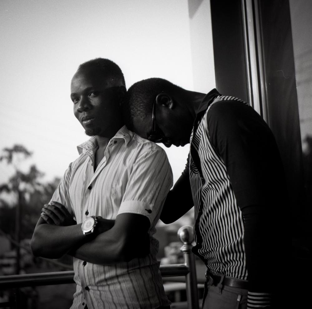 On Monday, Ugandan President Yoweri Museveni signed into law a bill that toughens penalties against gay people and makes some homosexual acts crimes punishable by life in prison. Here, Akram Kalungi, a gay man from Kampala who works in a video store, is pictured with his partner. Image by Daniella Zalcman. Uganda, 2014. Media file: kuchucouples09.jpg