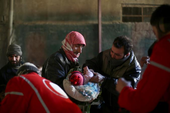 A Syrian infant receives a polio vaccination last month in a rebel-held area in a Damascus suburb. Though no new polio cases have been reported in more than a year, vaccinators must maintain their efforts because the health system has been destroyed in much of the country. Photograph by Abd Doumany, AFP/Getty. Syria, 2015.