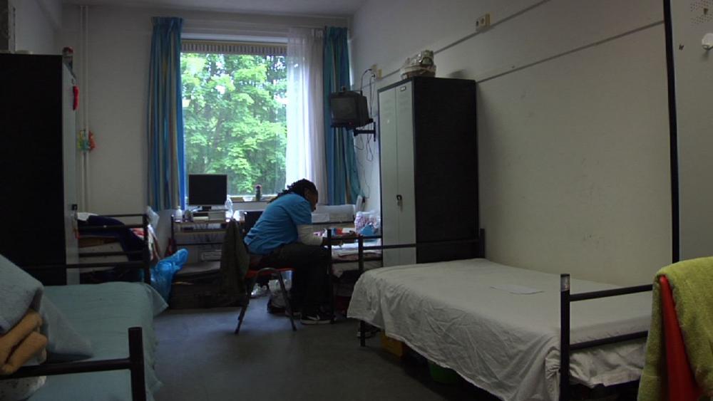 Simone in the dorm room at the Crailo Refugee Camp in Holland she shared with three other refugee women. Image by Micah Fink. Netherlands, 2009.
